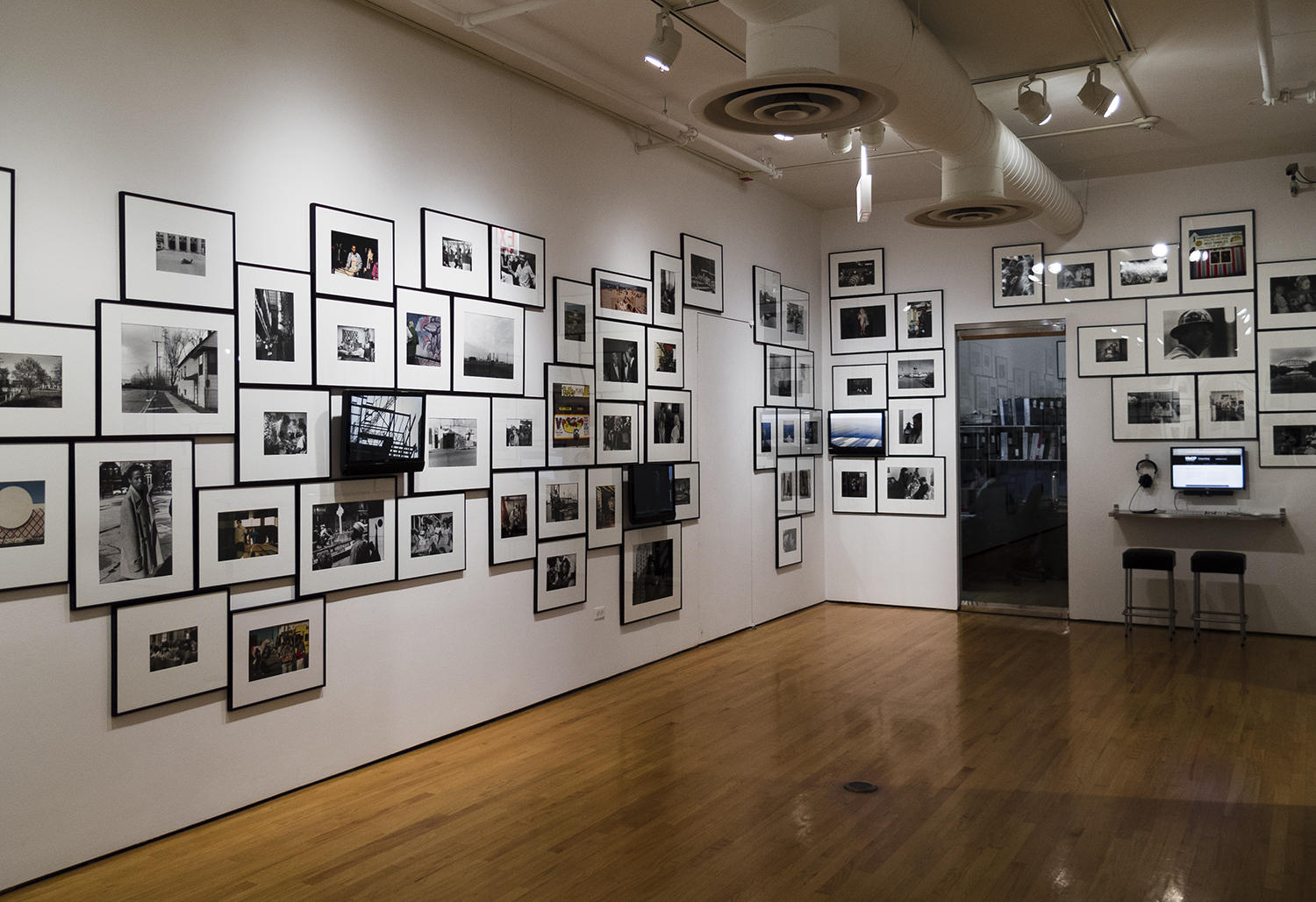 Jan Tichy, Installation view of 1979:1-2012:21 Jan Tichy Works with the MoCP Collection, Print Studio Room with images from Changing Chicago Project and videos by Tichy, Museum of Contemporary Photography, Chicago. Image courtesy of the artist and the MoCP.