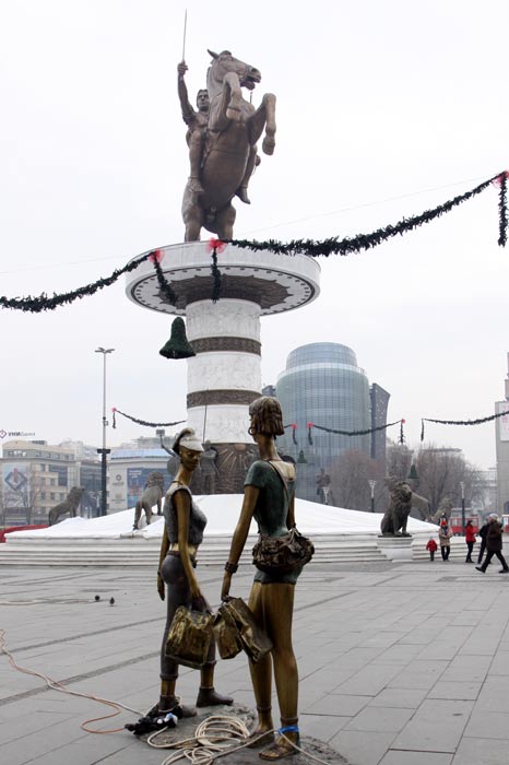 The Skopje city square. Warrior on a Horse monument (back), the “Accidental Meeting” sculpture, 2009. (front). Photo taken: 25.12.2011 Image Courtesy of Petar Kajevski