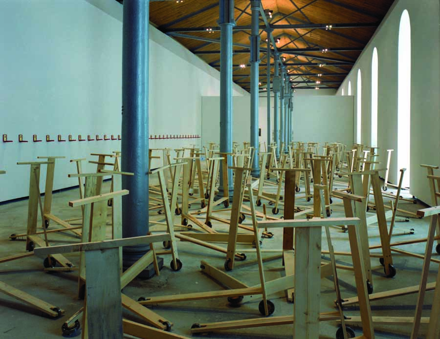 subREAL. "Eurasia," 1992, installation view, 300 wooden scooters with roller bearing wheels, 50 cases with the medal “Meritul Cultural Clasa V." 3rd Istanbul Biennial. Image courtesy of subREAL.