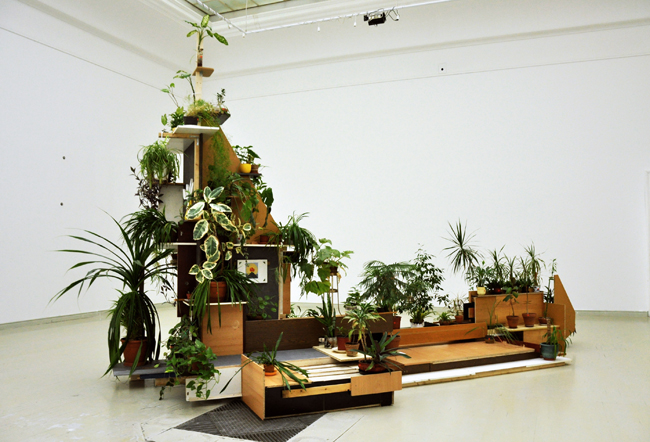 Tamás Kaszás, “Council of the Plants,” 2009, materials from recycled furniture, plants, video loop. Image courtesy of the artist.