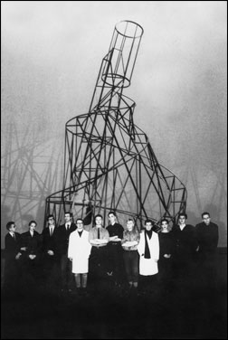 Members of the NSK Collective in front of the model of Vladimir Tatlin's Monument for the III. International (1919-1920) which was reconstructed for their performance 'Krst Pod Triglavom' (Baptism under Triglav, 1986) in the Cankarjev Dom in Ljubljana (Photo: NSK).
