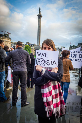 Scene from protest against cyanide mining of Rosia Montana, Romania. Protesters are displaying signs with drawings made by Dan Perjovschi, 2013. Image courtesy of the artist.