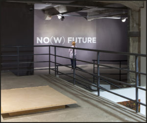 photograph of a grey wall with "No(w) Future" in white letters.