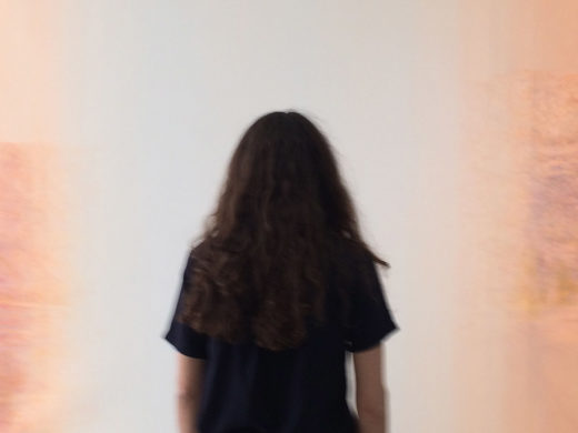 Photograph of back of woman with long hair