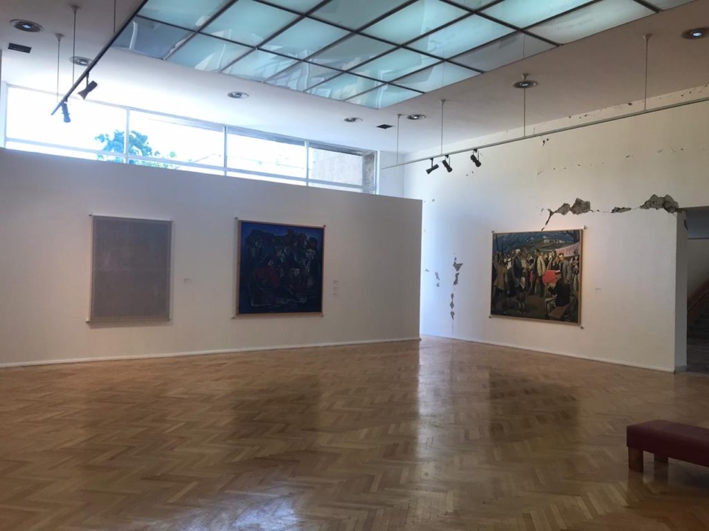 interior of the exhibition with cracks in the walls of the National Gallery of Arts visible