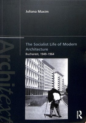 book cover with a b&w photo of a man taking a photo of a socialist housing block