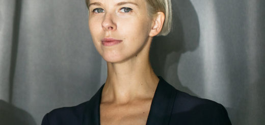 Image of Maria Lanko, a woman with short blonde hair, against a gray curtain