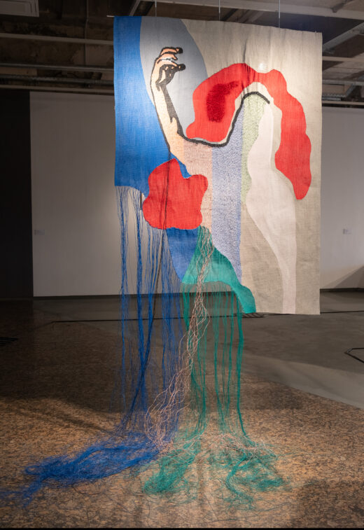 A tapestry made of wires forms an image reminiscent of a Yugoslav-era print of a worker pumping her fist in the air.